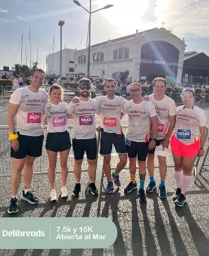 A group of Delibreads people wearing company T-shirts at a local race