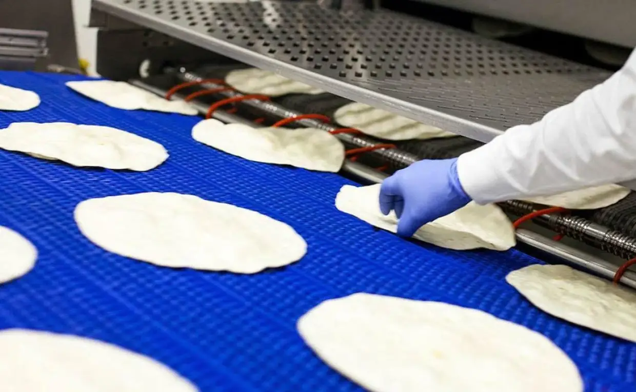 Freshly sheeted tortillas moving along a production line at the Llíria plant